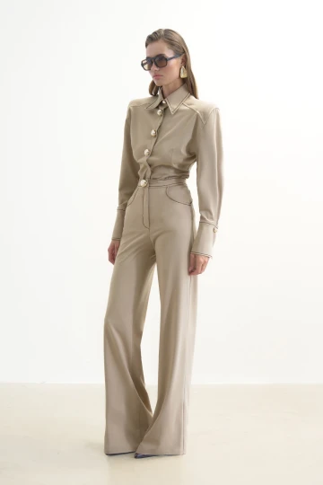 BEIGE TROUSERS WITH GOLD BUTTONS AND BROWN STITCHING DETAIL